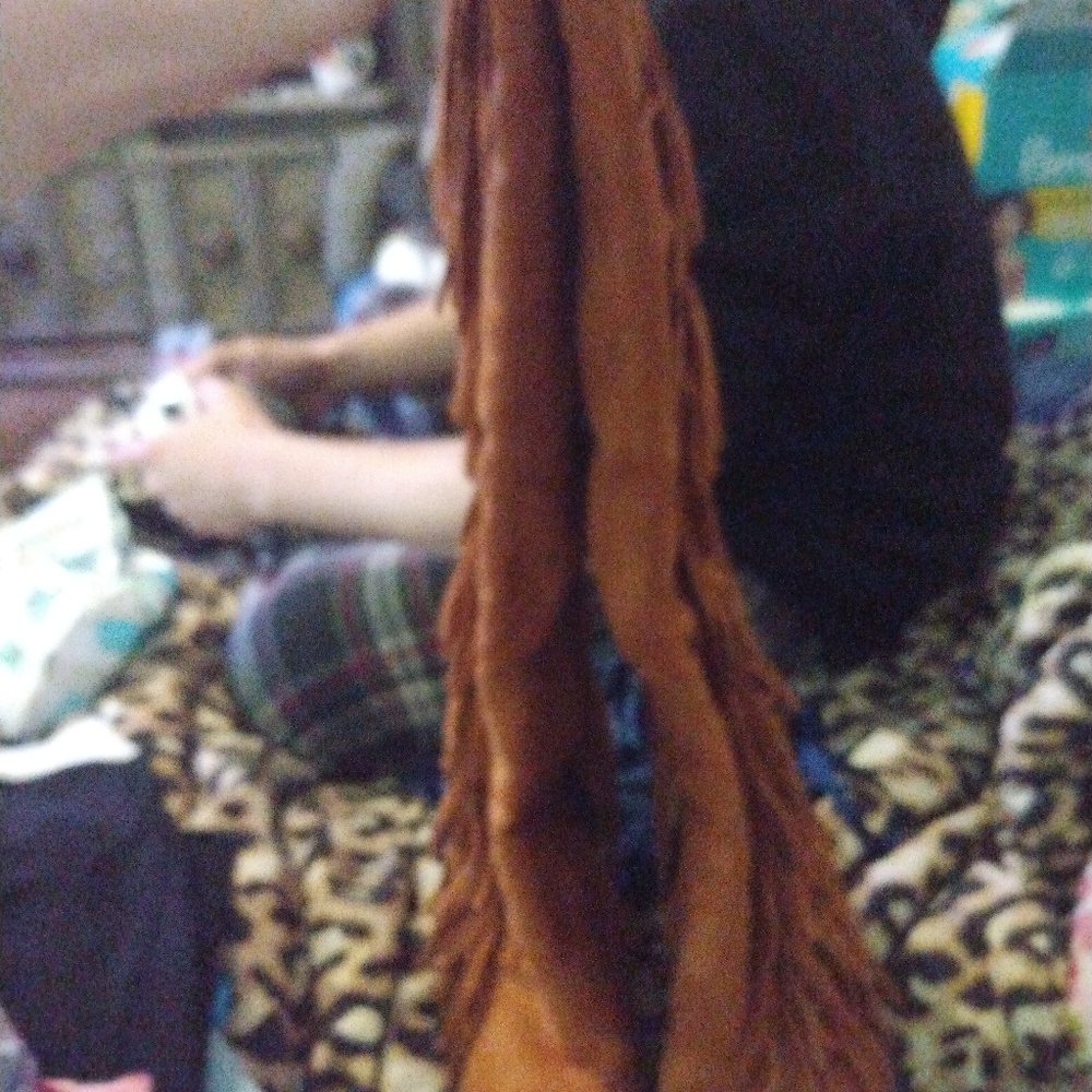 Brown heeled boots with fringe